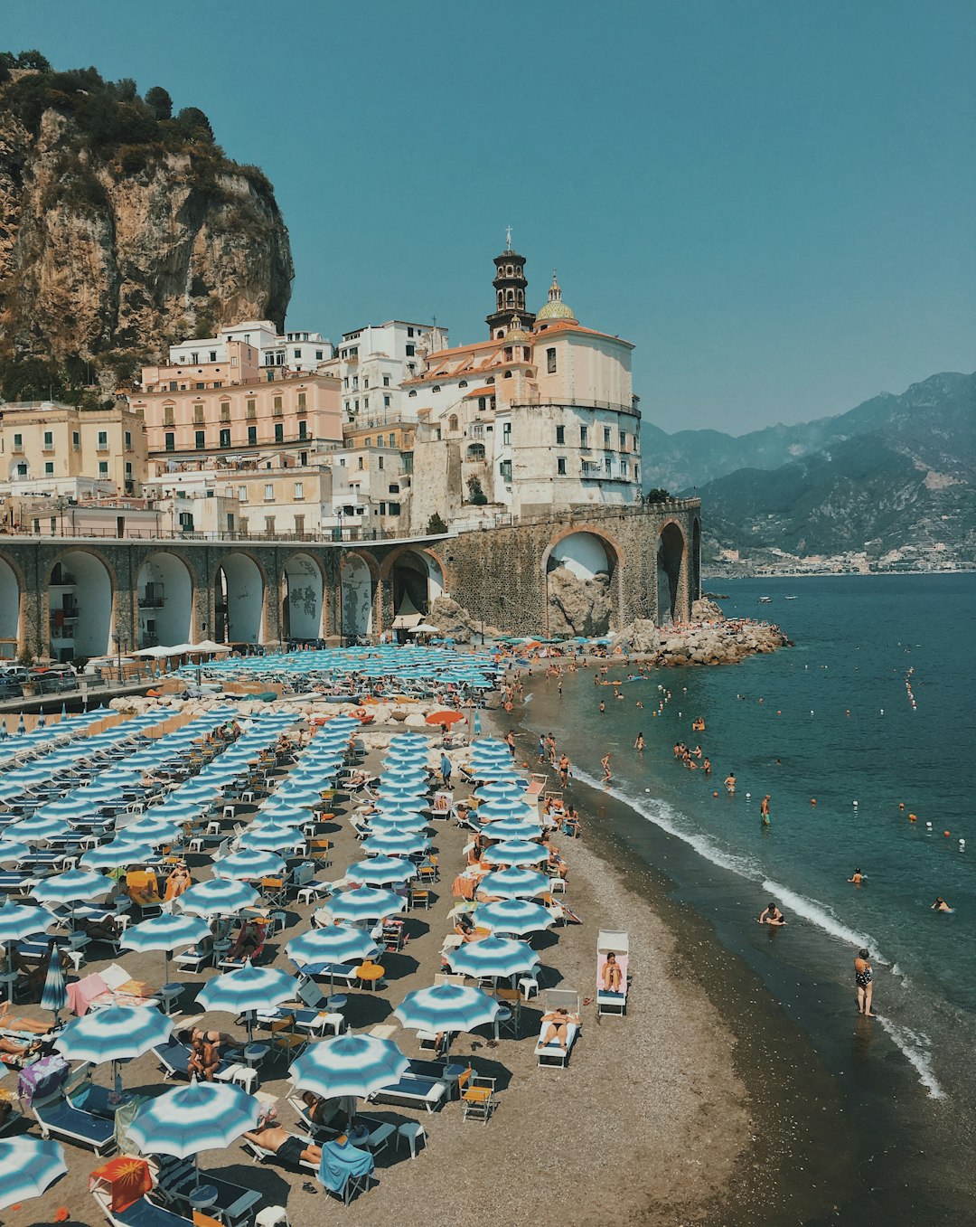 Mediterranean beach umbrellas and sea, editorial destination photography